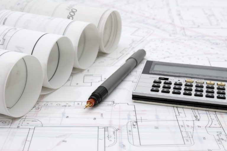 Calculator, pen and buiding blueprints